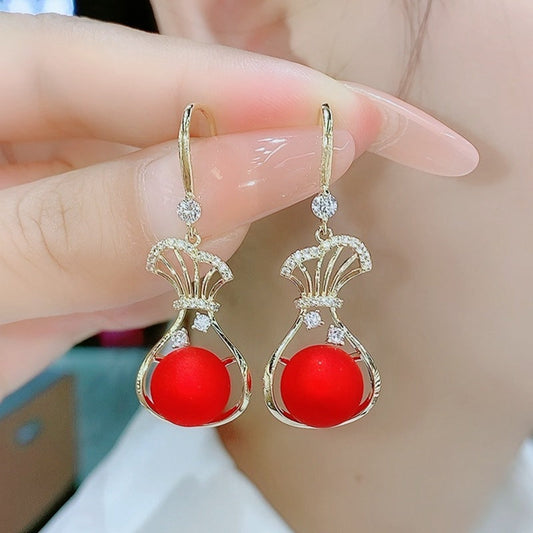 Red purse pearl earrings